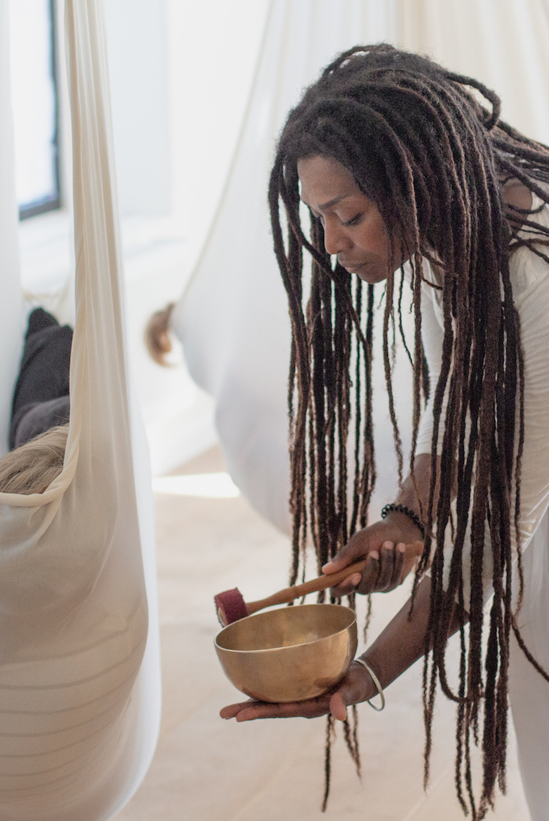 Woman playing a gong bowl